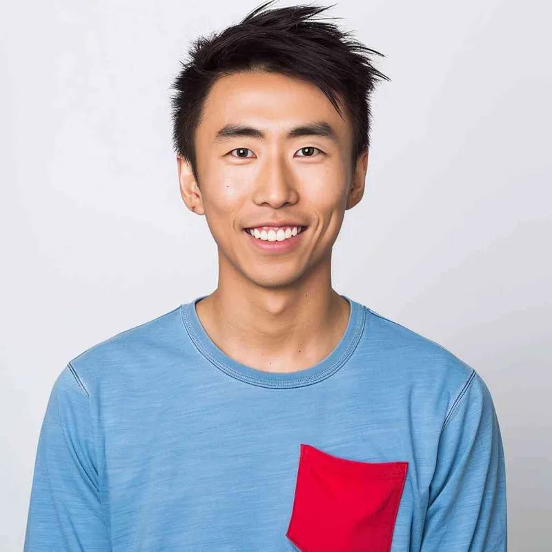 A young Chinese man with short black hair, wearing a blue long-sleeved shirt with a red pocket on the chest area of his right hand is smiling at the camera. The background color should be white to highlight his face. He has an Asian nose shape, medium skin tone, round eyes, and thin eyebrows. His overall appearance conveys friendliness or confidence. in the style of --ar 25:32 - style1部分