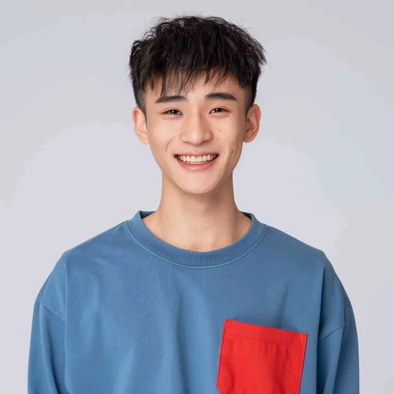 A young Chinese man with short black hair, wearing a blue long-sleeved shirt with a red pocket on the chest area of his right hand is smiling at the camera. The background color should be white to highlight his face. He has an Asian nose shape, medium skin tone, round eyes, and thin eyebrows. His overall appearance conveys friendliness or confidence. in the style of --ar 25:32 - style2部分