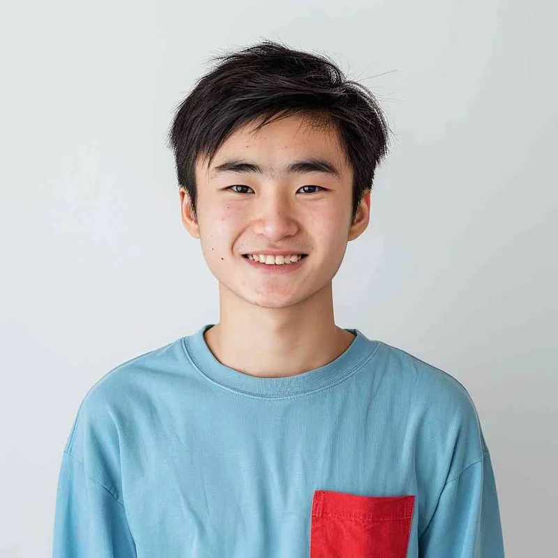 A young Chinese gril with short black hair, wearing a blue long-sleeved shirt with a red pocket on the chest area of his right hand is smiling at the camera. The background color should be white to highlight his face. He has an Asian nose shape, medium skin tone, round eyes, and thin eyebrows. His overall appearance conveys friendliness or confidence. --ar 1:1 --q 1 --v 6.0 - style2部分