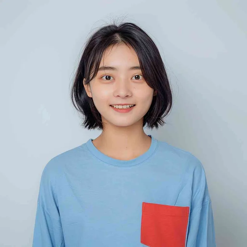 A young Chinese gril with short black hair, wearing a blue long-sleeved shirt with a red pocket on the chest area of his right hand is smiling at the camera. The background color should be white to highlight his face. she has an Asian nose shape, medium skin tone, round eyes, and thin eyebrows. her overall appearance conveys friendliness or confidence. --ar 1:1 --q 1 --v 6.0 - AI绘画作品展示 | Midjourney中文版生成
