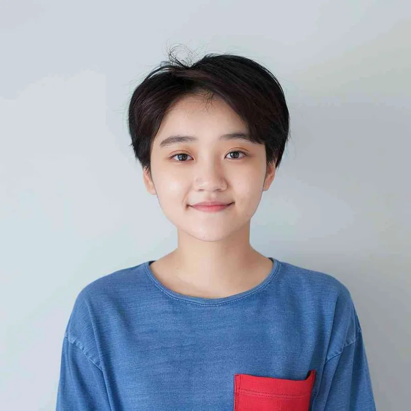A young Chinese gril with short black hair, wearing a blue long-sleeved shirt with a red pocket on the chest area of his right hand is smiling at the camera. The background color should be white to highlight his face. she has an Asian nose shape, medium skin tone, round eyes, and thin eyebrows. her overall appearance conveys friendliness or confidence. --ar 1:1 --q 1 --v 6.0 - AI绘画作品展示 | Midjourney中文版生成