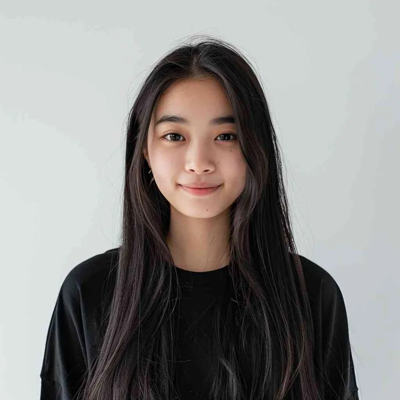 A Chinese girl with long black hair and wearing a dark long-sleeved round-neck T-shirt is smiling at the camera. The background color should be white to highlight his face. She has an Asian nose shape, medium skin tone, round eyes, and thin eyebrows. Her overall appearance conveys friendliness or confidence.--ar 1:1 --q 1 --v 6.0 - style1部分