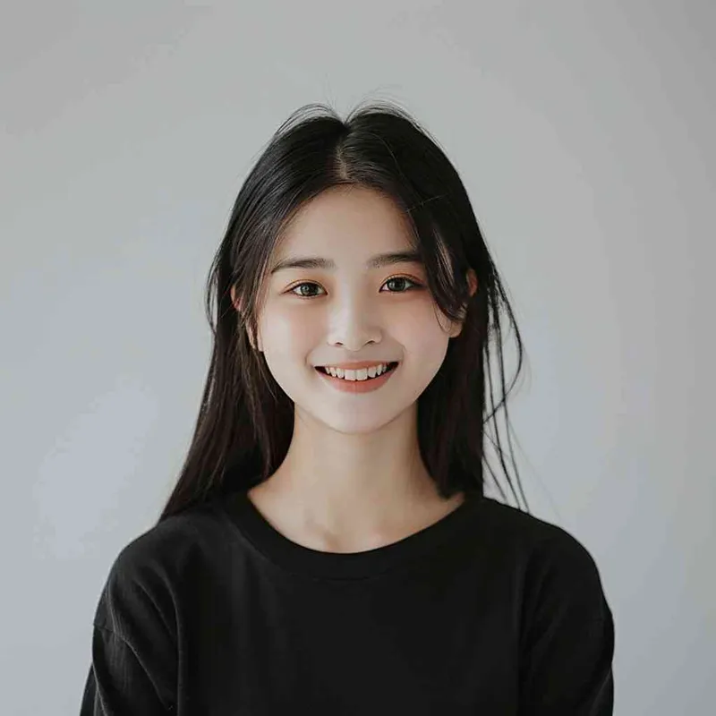 A Chinese girl with long black hair and wearing a dark long-sleeved round-neck T-shirt is smiling at the camera. The background color should be white to highlight his face. She has an Asian nose shape, medium skin tone, round eyes, and thin eyebrows. Her overall appearance conveys friendliness or confidence.--ar 1:1 --q 1 --v 6.0 - style2部分