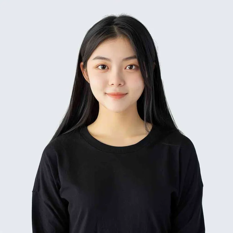 A Chinese girl with long black hair and wearing a dark long-sleeved round-neck T-shirt is smiling at the camera. The background color should be white to highlight his face. She has an Asian nose shape, medium skin tone, round eyes, and thin eyebrows. Her overall appearance conveys friendliness or confidence.--ar 1:1 --q 1 --v 6.0 - style3部分