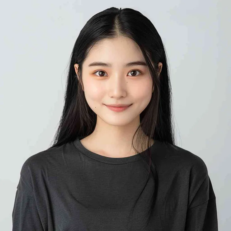 A Chinese girl with long black hair and wearing a dark long-sleeved round-neck T-shirt is smiling at the camera. The background color should be white to highlight his face. She has an Asian nose shape, medium skin tone, round eyes, and thin eyebrows. Her overall appearance conveys friendliness or confidence.--ar 1:1 --q 1 --v 6.0 - style4部分