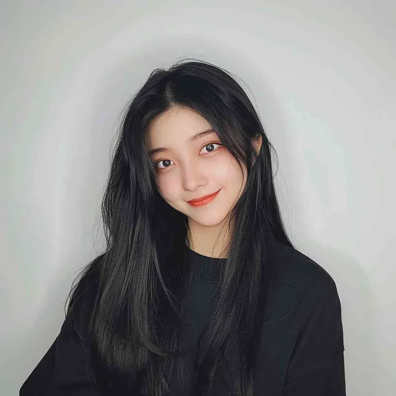 A Chinese girl with long black hair and wearing a dark long-sleeved round-neck T-shirt is smiling at the camera. The background color should be white to highlight his face. She has an Asian nose shape, medium skin tone, round eyes, and thin eyebrows. Her overall appearance conveys friendliness or confidence.--ar 1:1 --q 1 --v 6.0 - style4部分