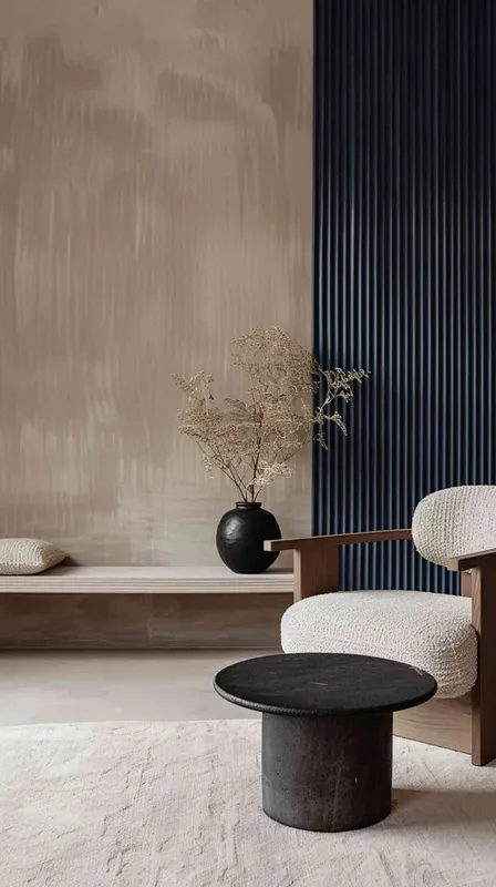 A minimalist living room with a chair andtable, featuring navy blue vertical stripedwall panels on the right side of thepicture. The left side features beige wallscreating an elegant space. A small blackround vase holding dried flowers sitsatop one end. In front stands a simplecoffee table with a single cushion inlight grey color on top of it.--ar 3:4 --s 750 --v 6.0 --style raw - style2部分