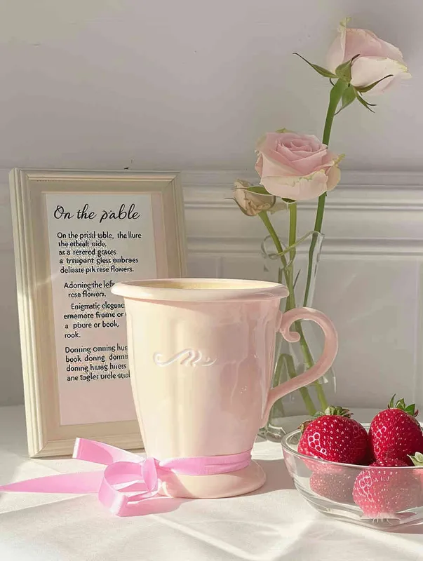 On the white table, the pink cup is placed in the middle, the left side is placed a vase with pink rose flowers, the vase is transparent glass, behind the cup is placed a picture frame or book, with pink and white as the main color, the right side of the cup is placed a strawberry fruit bowl, the overall style is clean, clear, ins wind, girlish feeling, dreamlike feeling.The background is a soft white wall, with pink flowers in the vase, creating a dreamy atmosphere--Ar 3:4 - style2部分