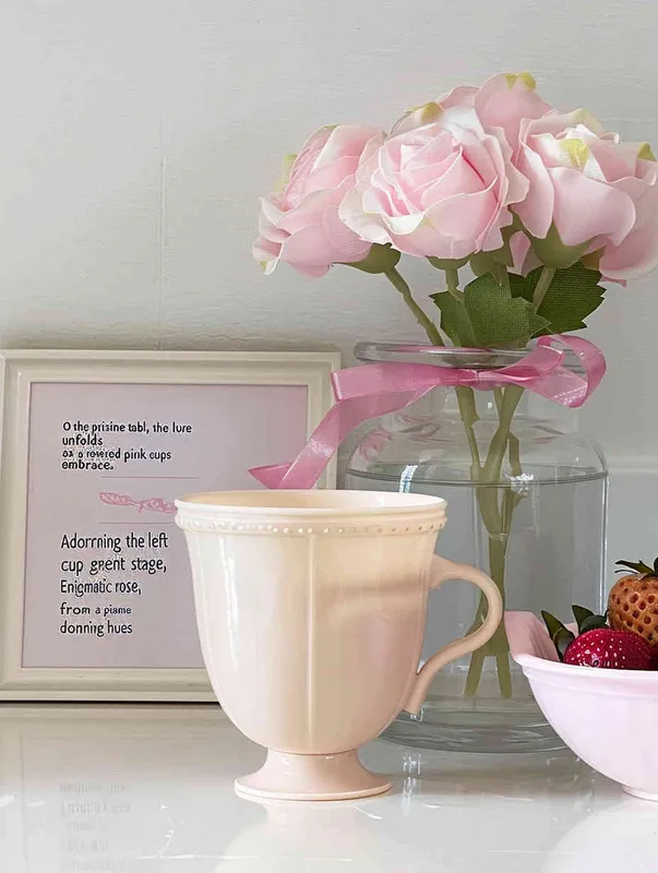 On the white table, the pink cup is placed in the middle, the left side is placed a vase with pink rose flowers, the vase is transparent glass, behind the cup is placed a picture frame or book, with pink and white as the main color, the right side of the cup is placed a strawberry fruit bowl, the overall style is clean, clear, ins wind, girlish feeling, dreamlike feeling.The background is a soft white wall, with pink flowers in the vase, creating a dreamy atmosphere--Ar 3:4 - style3部分